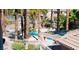 Inviting community pool area with palm trees, lounge chairs, and clear blue water for relaxation at 10553 Pine Pointe Ave # 201, Las Vegas, NV 89144