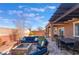 An outdoor space with comfortable seating, a fire pit, and an area for dining al fresco, perfect for relaxation and entertainment at 10568 Pelican Island Ave, Las Vegas, NV 89166