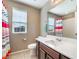 A well-lit bathroom featuring a vanity with sink, toilet, and bathtub at 10568 Pelican Island Ave, Las Vegas, NV 89166