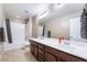 Bathroom featuring double sinks, a large mirror, and a shower with bathtub combination at 10568 Pelican Island Ave, Las Vegas, NV 89166