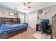 Bedroom with built-in shelving, a ceiling fan, and natural light from the window at 10568 Pelican Island Ave, Las Vegas, NV 89166