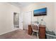 Bright bedroom featuring a desk, sewing machine, and wall-mounted television at 10568 Pelican Island Ave, Las Vegas, NV 89166
