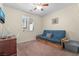 Cozy bedroom with carpet, a futon, and a window providing natural light at 10568 Pelican Island Ave, Las Vegas, NV 89166