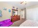 Bedroom featuring a dresser, plush seating, and ample closet space at 10568 Pelican Island Ave, Las Vegas, NV 89166