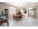 Formal dining room with tile floors, chandelier, and plenty of natural light from the window at 10568 Pelican Island Ave, Las Vegas, NV 89166