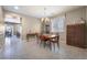 Spacious dining room featuring tile flooring, a chandelier, and classic wood furniture at 10568 Pelican Island Ave, Las Vegas, NV 89166