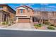 Charming two-story home featuring a paved driveway, two car garage and manicured landscaping at 10568 Pelican Island Ave, Las Vegas, NV 89166