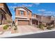 Inviting two-story home with a two-car garage, desert landscaping, and paved driveway at 10568 Pelican Island Ave, Las Vegas, NV 89166