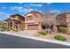 Attractive two story home with a two car garage, desert landscaping, and a paved driveway at 10568 Pelican Island Ave, Las Vegas, NV 89166
