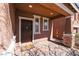 Charming covered front porch with brick support columns and a 