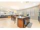 Open-concept kitchen featuring an island with seating, a sink and stainless steel appliances at 10568 Pelican Island Ave, Las Vegas, NV 89166