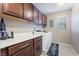 Well-organized laundry room with modern appliances, sleek cabinets and ample counter space at 10568 Pelican Island Ave, Las Vegas, NV 89166