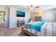 Cozy main bedroom with a mounted TV, plush bed, and neutral tones, creating a serene ambiance at 10568 Pelican Island Ave, Las Vegas, NV 89166