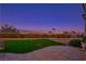 A backyard with a telescope, green grass, beautiful plants, and a stunning mountain view at 10716 Bennington Ct, Las Vegas, NV 89134