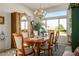 Traditional dining room with wood table and chairs with large window view at 10716 Bennington Ct, Las Vegas, NV 89134