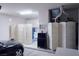 Spacious garage with car, tool box, privacy screens, and view to adjacent laundry room at 10716 Bennington Ct, Las Vegas, NV 89134