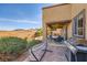 Inviting backyard featuring a covered patio, dining set, grill, and hammock near lush artificial grass at 1178 Yellow Orchid St, Henderson, NV 89002