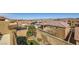 Backyard view showcases a two-story home, privacy walls, artificial grass, and mountain views at 1178 Yellow Orchid St, Henderson, NV 89002