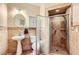 Bathroom featuring a shower with glass door, pedestal sink, and tiled walls at 1178 Yellow Orchid St, Henderson, NV 89002