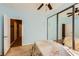 Cozy bedroom featuring a ceiling fan and a mirrored closet, creating a relaxing space at 1178 Yellow Orchid St, Henderson, NV 89002