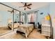Bedroom with mirrored closet doors, ceiling fan, and natural light at 1178 Yellow Orchid St, Henderson, NV 89002