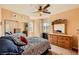 Comfortable bedroom featuring carpet floors, lots of natural light, and a ceiling fan at 1178 Yellow Orchid St, Henderson, NV 89002