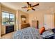 Bedroom features a ceiling fan, window, and dressers for ample storage at 1178 Yellow Orchid St, Henderson, NV 89002