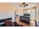 Comfortable bedroom with a ceiling fan, large windows, and doorway to another room at 1178 Yellow Orchid St, Henderson, NV 89002