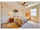 This cozy bedroom features carpet floors, neutral walls, and a ceiling fan for added comfort at 1178 Yellow Orchid St, Henderson, NV 89002