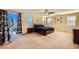 Spacious bedroom with a dark comforter, large windows, and a sliding door to the outside at 1178 Yellow Orchid St, Henderson, NV 89002