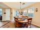 Warm dining room with a chandelier and a wooden table set for six at 1178 Yellow Orchid St, Henderson, NV 89002
