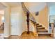 Elegant foyer featuring tile flooring, a staircase with decorative ironwork, and a tall vase at 1178 Yellow Orchid St, Henderson, NV 89002