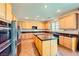 Spacious kitchen with stainless steel appliances, center island, and tile flooring at 1178 Yellow Orchid St, Henderson, NV 89002