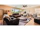 Bright living room with large windows, tile floors, and comfortable seating at 1178 Yellow Orchid St, Henderson, NV 89002