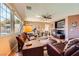 Bright living room with large windows, ceiling fan, and comfortable seating at 1178 Yellow Orchid St, Henderson, NV 89002