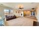 This large living room boasts carpet floors, neutral walls, recessed lights, and lots of natural light at 1178 Yellow Orchid St, Henderson, NV 89002