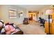 View of living area with workspace, comfortable seating, and large windows at 1178 Yellow Orchid St, Henderson, NV 89002