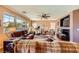 Comfortable living room with ample natural light, a ceiling fan, and a cozy fireplace at 1178 Yellow Orchid St, Henderson, NV 89002