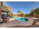 Inviting backyard pool and spa surrounded by lush landscaping and mature palm trees at 1178 Yellow Orchid St, Henderson, NV 89002