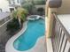 View from balcony overlooking sparkling swimming pool and tropical landscaping, features a hot tub at 1178 Yellow Orchid St, Henderson, NV 89002