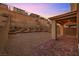 Backyard patio, gravel area, terraced landscaping, and an outdoor living area at 12521 Lylan Ridge St, Las Vegas, NV 89138