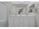 Bathroom featuring double vanity sinks, sleek cabinetry, and a large mirror at 12521 Lylan Ridge St, Las Vegas, NV 89138