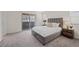 Bedroom featuring a plush bed frame, sliding glass door and neutral decor at 12521 Lylan Ridge St, Las Vegas, NV 89138