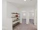Bright hallway with an ornate shelving unit plus an entrance to two bedrooms at 12521 Lylan Ridge St, Las Vegas, NV 89138
