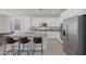 This is a gourmet kitchen featuring stainless steel appliances, an island with seating and white cabinets at 12521 Lylan Ridge St, Las Vegas, NV 89138