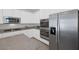 Bright kitchen featuring stainless steel appliances, granite countertops, and white cabinetry at 12521 Lylan Ridge St, Las Vegas, NV 89138