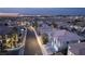 Gorgeous neighborhood view with tile roofs, lush lawns, and a stunning city skyline in the background at 1436 Via Merano St, Henderson, NV 89052