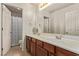 Bathroom featuring double sinks, wood cabinets, and a separate toilet room at 1436 Via Merano St, Henderson, NV 89052
