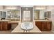 Luxurious bathroom with a deep soaking tub, dual sinks, and stylish tile work at 1436 Via Merano St, Henderson, NV 89052