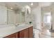 Bright bathroom with a single sink vanity, and glass enclosed shower at 1436 Via Merano St, Henderson, NV 89052